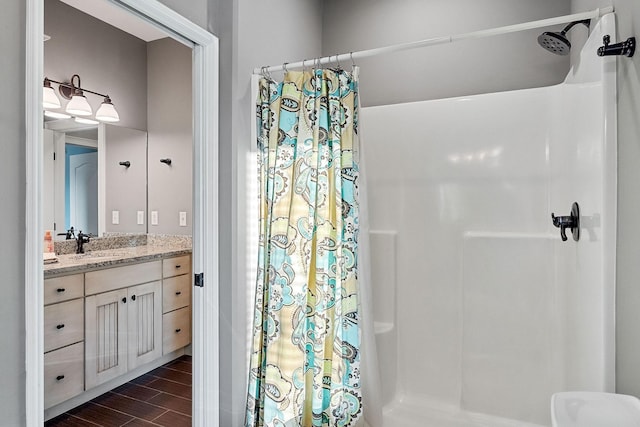 bathroom featuring wood finished floors, vanity, and a shower with curtain
