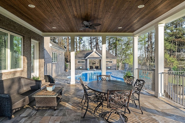sunroom featuring ceiling fan and outdoor dining space