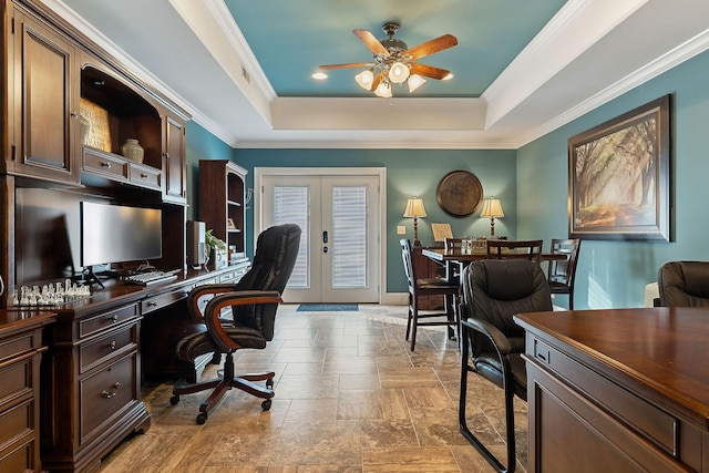 office space featuring ceiling fan, stone tile flooring, french doors, a raised ceiling, and ornamental molding