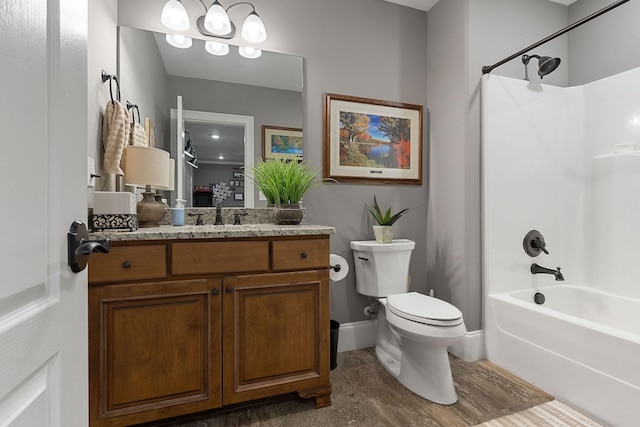 full bathroom featuring baseboards, toilet, vanity, and  shower combination