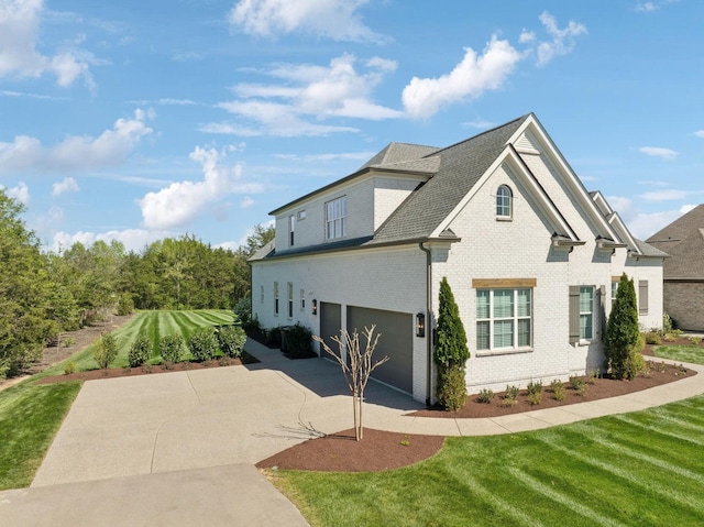 2041 Kingsbarns Dr, Nolensville, TN 37135 - view of home's exterior featuring concrete driveway, brick siding, a lawn, and a garage
