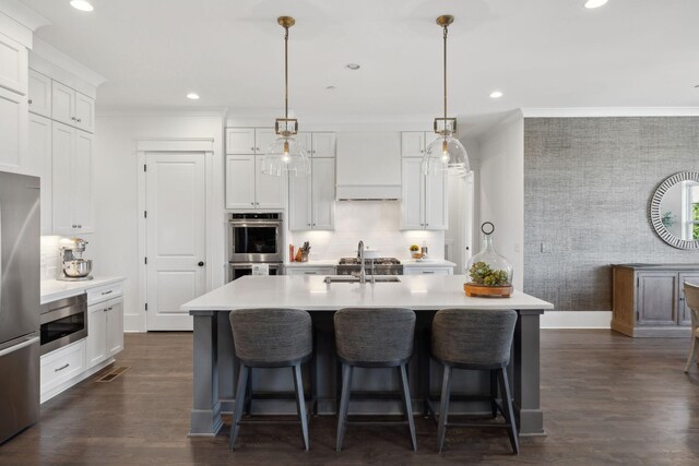 2041 Kingsbarns Dr, Nolensville, TN 37135 - kitchen featuring an accent wall, a sink, wallpapered walls, stainless steel appliances, and light countertops