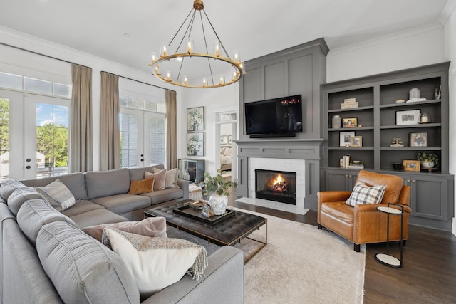 2041 Kingsbarns Dr, Nolensville, TN 37135 - living area featuring an inviting chandelier, ornamental molding, french doors, and dark wood-style floors
