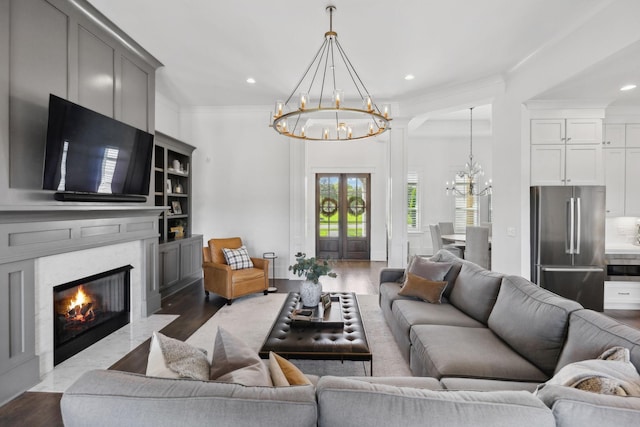 2041 Kingsbarns Dr, Nolensville, TN 37135 - living area featuring a fireplace with flush hearth, dark wood-style floors, an inviting chandelier, and recessed lighting