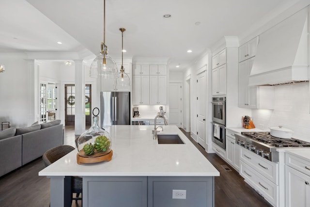 2041 Kingsbarns Dr, Nolensville, TN 37135 - kitchen featuring a sink, tasteful backsplash, open floor plan, appliances with stainless steel finishes, and premium range hood