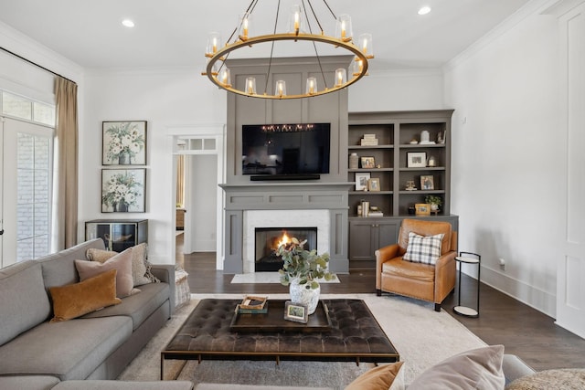2041 Kingsbarns Dr, Nolensville, TN 37135 - living room featuring a fireplace, wood finished floors, crown molding, and a notable chandelier