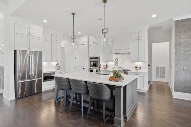 2041 Kingsbarns Dr, Nolensville, TN 37135 - kitchen with custom exhaust hood, decorative backsplash, stainless steel appliances, light countertops, and recessed lighting