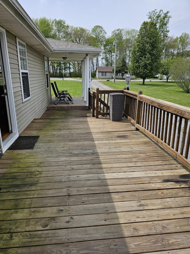 deck featuring a lawn and a porch