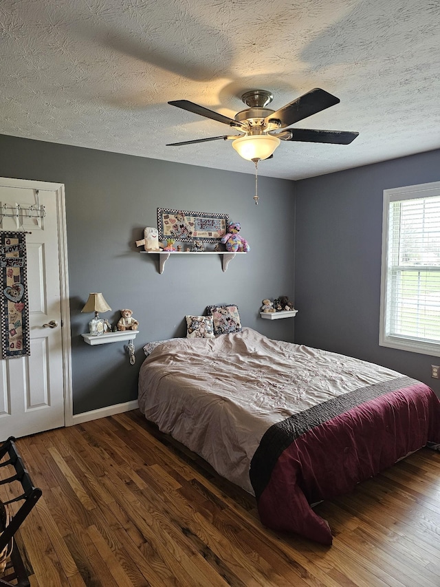 bedroom featuring wood finished floors and a textured ceiling