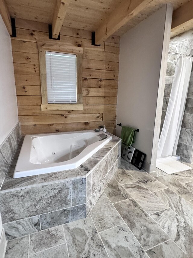 full bath with beam ceiling, a stall shower, a tub with jets, wood ceiling, and wooden walls