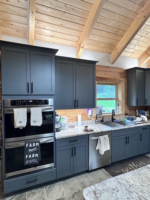 kitchen featuring wooden ceiling, appliances with stainless steel finishes, and beamed ceiling