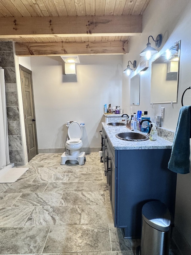 bathroom featuring baseboards, vanity, wooden ceiling, and beam ceiling