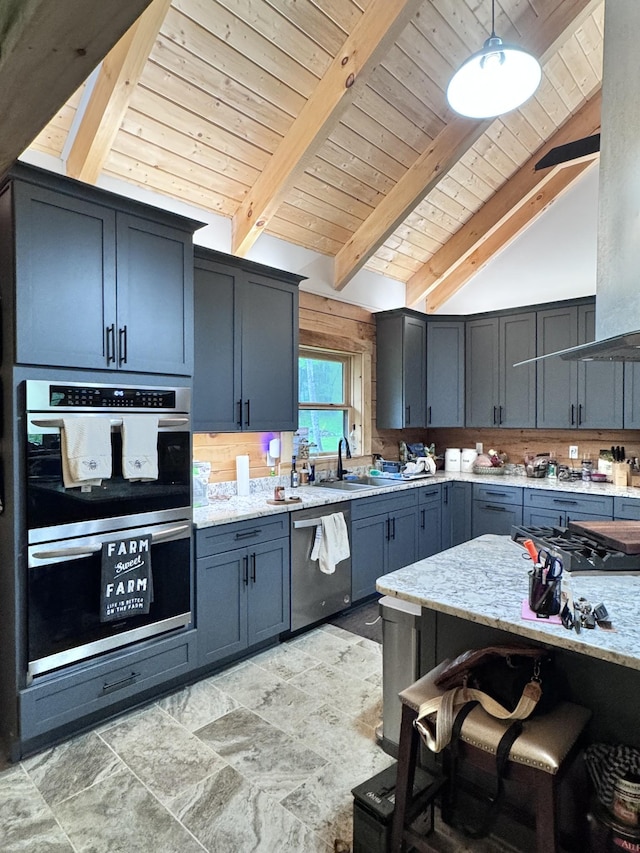 kitchen with wooden ceiling, a sink, light stone countertops, lofted ceiling with beams, and appliances with stainless steel finishes