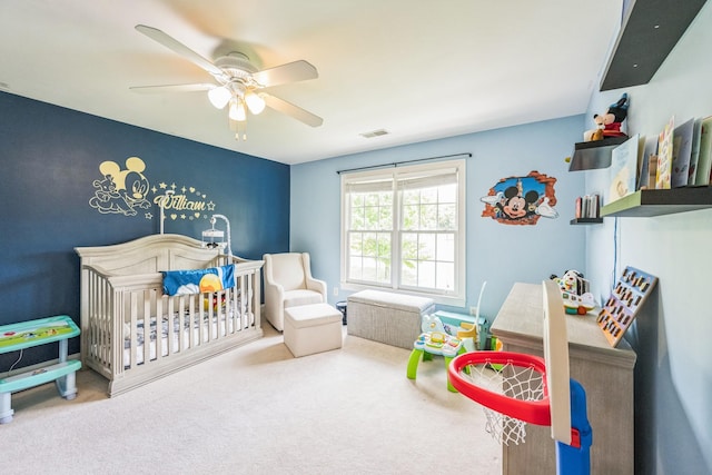 bedroom featuring a nursery area, a ceiling fan, carpet flooring, and visible vents