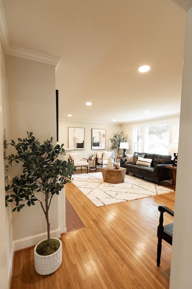 living area with recessed lighting, ornamental molding, baseboards, and wood finished floors