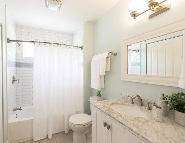 bathroom featuring toilet, visible vents, shower / tub combo with curtain, and vanity