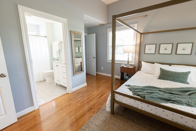 bedroom featuring baseboards and light wood-type flooring