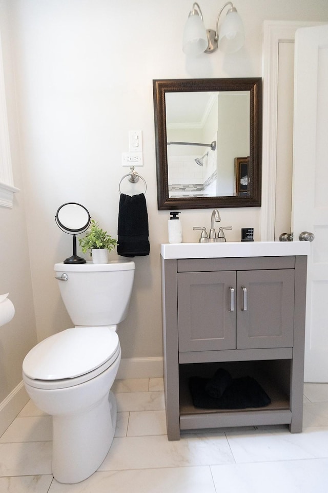 bathroom featuring baseboards, vanity, and toilet