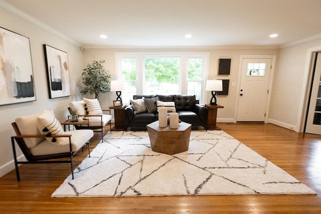 living room featuring baseboards, ornamental molding, recessed lighting, and wood finished floors
