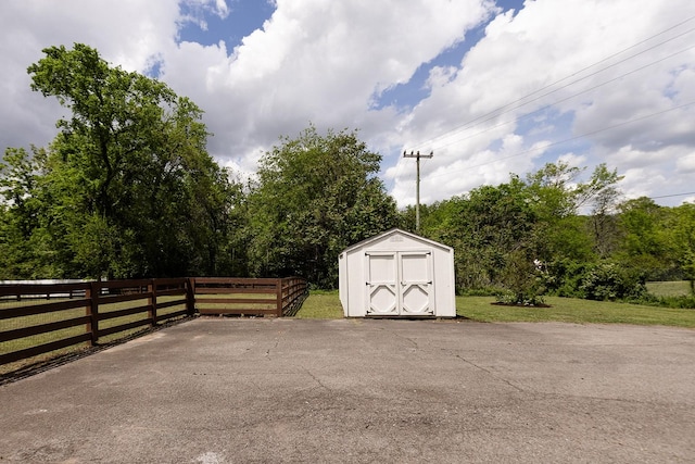 view of shed featuring fence