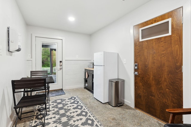 entrance foyer with baseboards and light colored carpet