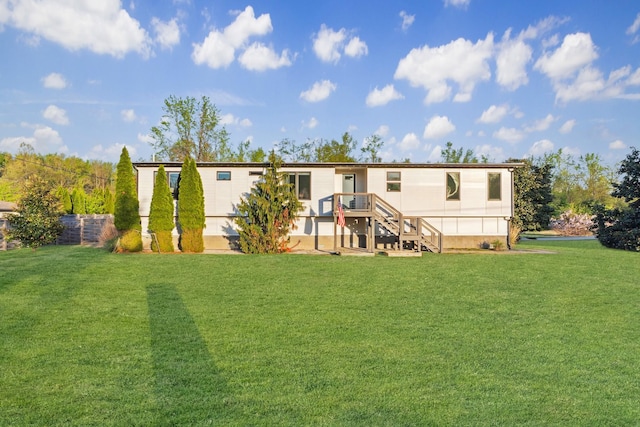 rear view of house featuring a lawn