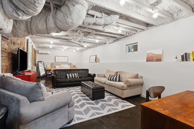 living area featuring concrete floors and an AC wall unit