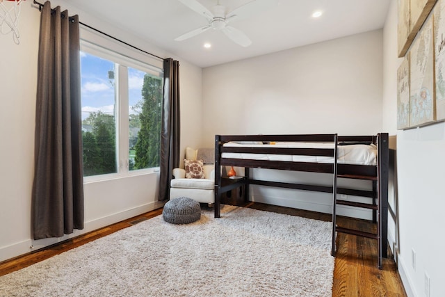 bedroom featuring baseboards, a ceiling fan, wood finished floors, and recessed lighting