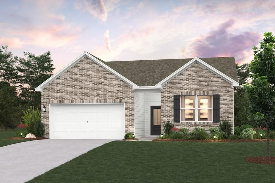 269 Subban Ct, Lebanon, TN 37087 - view of front of house with an attached garage, brick siding, driveway, and a front lawn