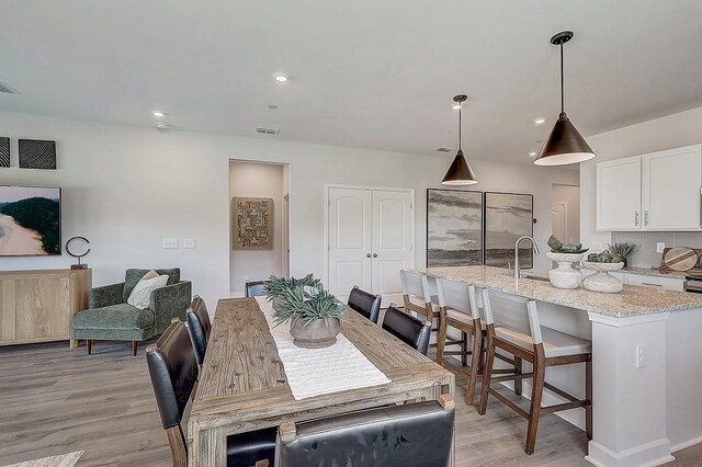 dining space featuring recessed lighting, visible vents, and light wood finished floors
