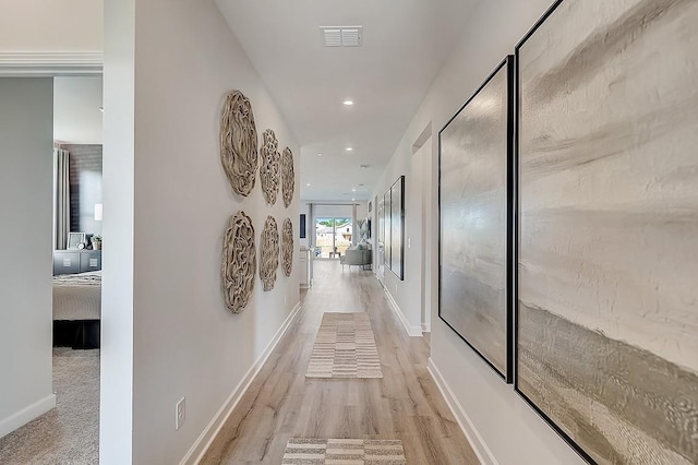 corridor featuring baseboards, light wood-style floors, visible vents, and recessed lighting