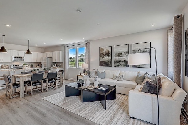 living room with recessed lighting and light wood-style floors