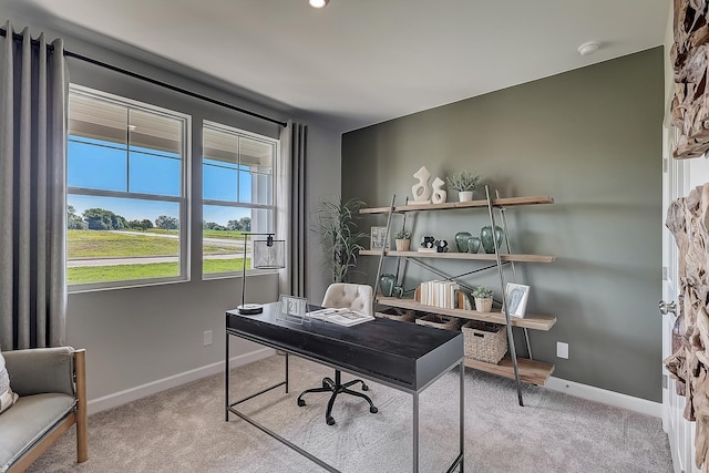 carpeted office space with baseboards