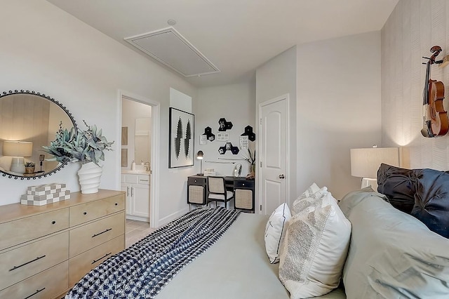 bedroom with attic access, ensuite bathroom, and light tile patterned floors