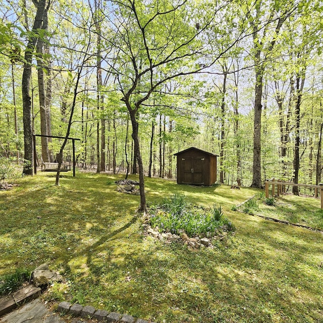 view of yard featuring a storage unit and an outbuilding