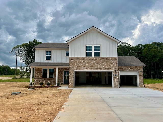 2544 Beverly Gail Rd, Pleasant View, TN 37146 - view of front facade with board and batten siding, driveway, brick siding, and a garage