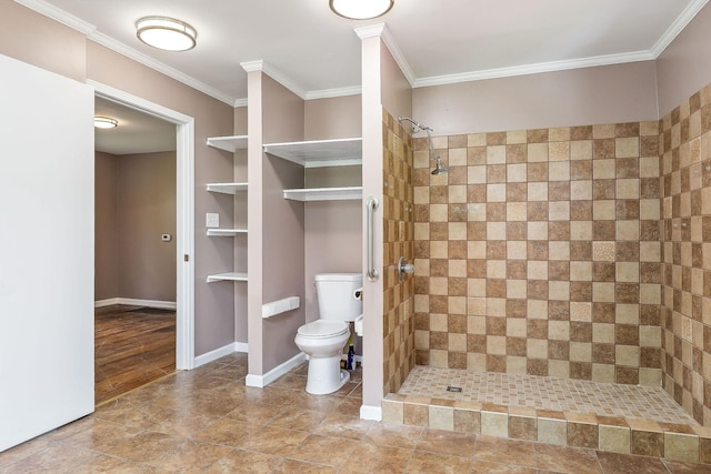 bathroom featuring toilet, baseboards, a shower stall, and crown molding