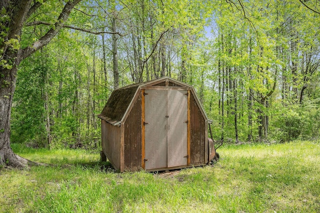 view of shed featuring a forest view