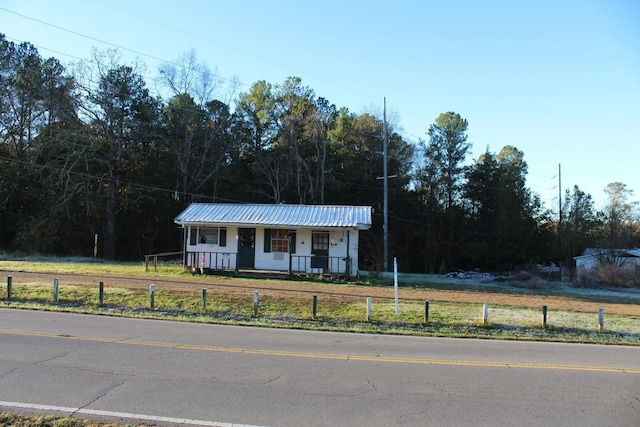 2537 Harrison Pike, Cleveland, TN 37311 - view of front of property with a porch, a view of trees, a fenced front yard, and metal roof