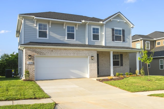 traditional home featuring an attached garage, concrete driveway, a front lawn, and central AC