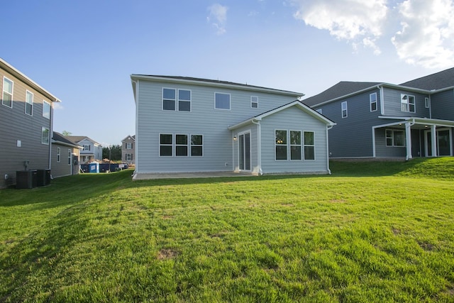 rear view of house featuring a lawn