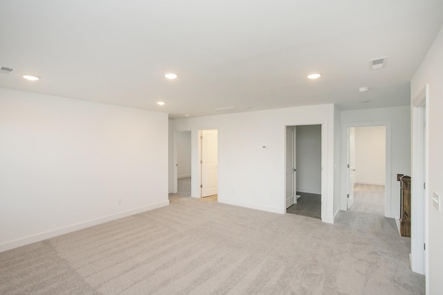 empty room with light carpet, baseboards, visible vents, and recessed lighting