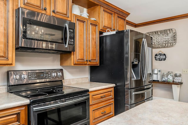 kitchen with light countertops, brown cabinetry, ornamental molding, and stainless steel appliances