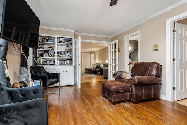 living area featuring hardwood / wood-style flooring, french doors, and ornamental molding