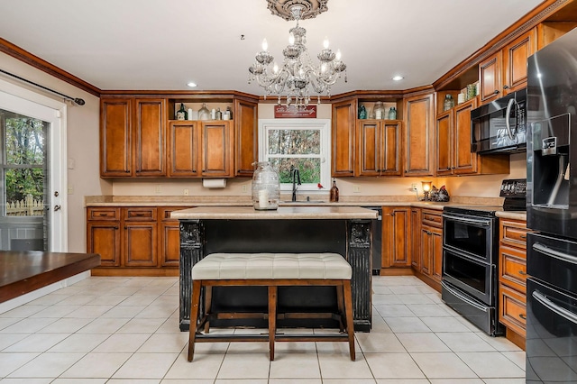 kitchen with open shelves, light countertops, a notable chandelier, and black appliances