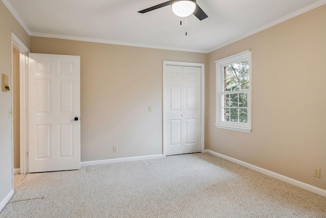 unfurnished bedroom featuring carpet floors, baseboards, and ornamental molding