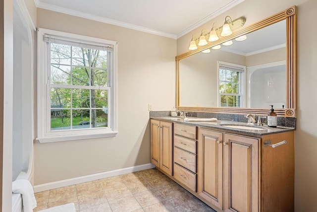 bathroom with baseboards, ornamental molding, a sink, and double vanity