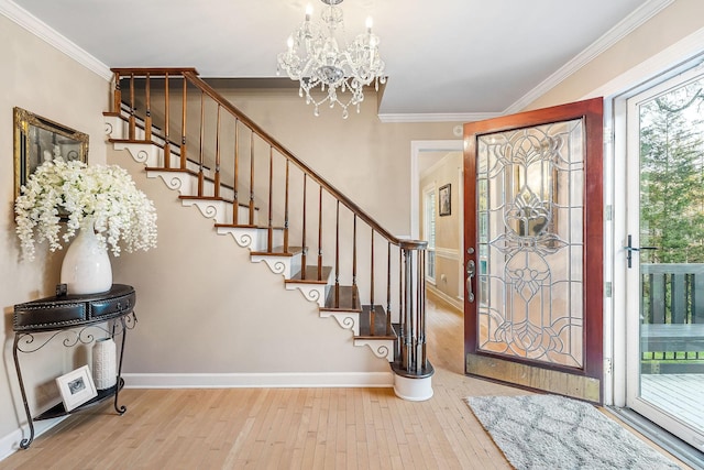 entryway with crown molding, stairway, and wood-type flooring