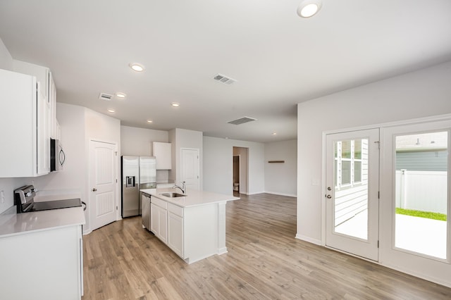 118 Olivia Cir, Chapel Hill, TN 37034 - kitchen featuring stainless steel appliances, white cabinets, a sink, light wood-type flooring, and light countertops