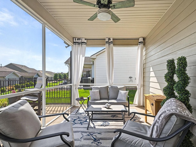 sunroom / solarium featuring an outdoor hangout area, wooden walls, a residential view, and ceiling fan